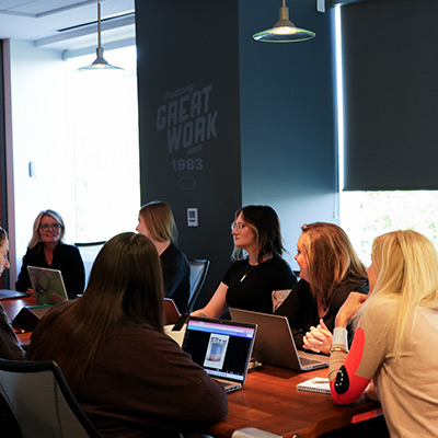 InkFox publicity team working in the boardroom discussing a authors campaign